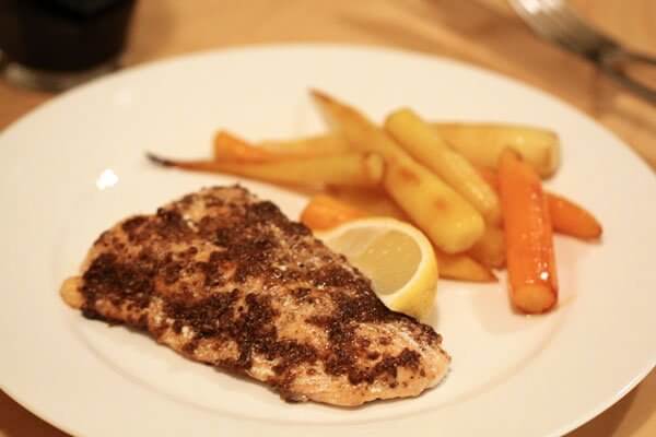 Olive oil poached salmon with Indian spices, served with pan-roasted carrots