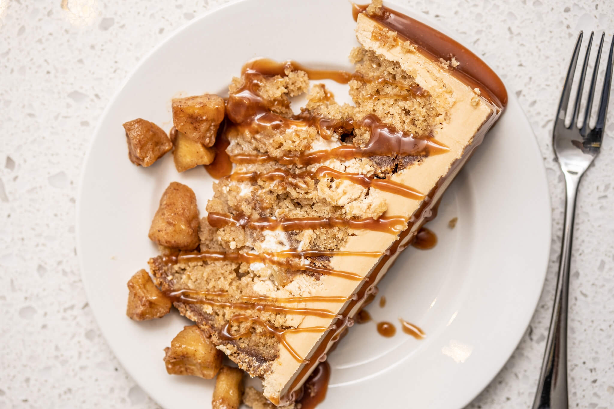 Slice caramel apple cheesecake cake