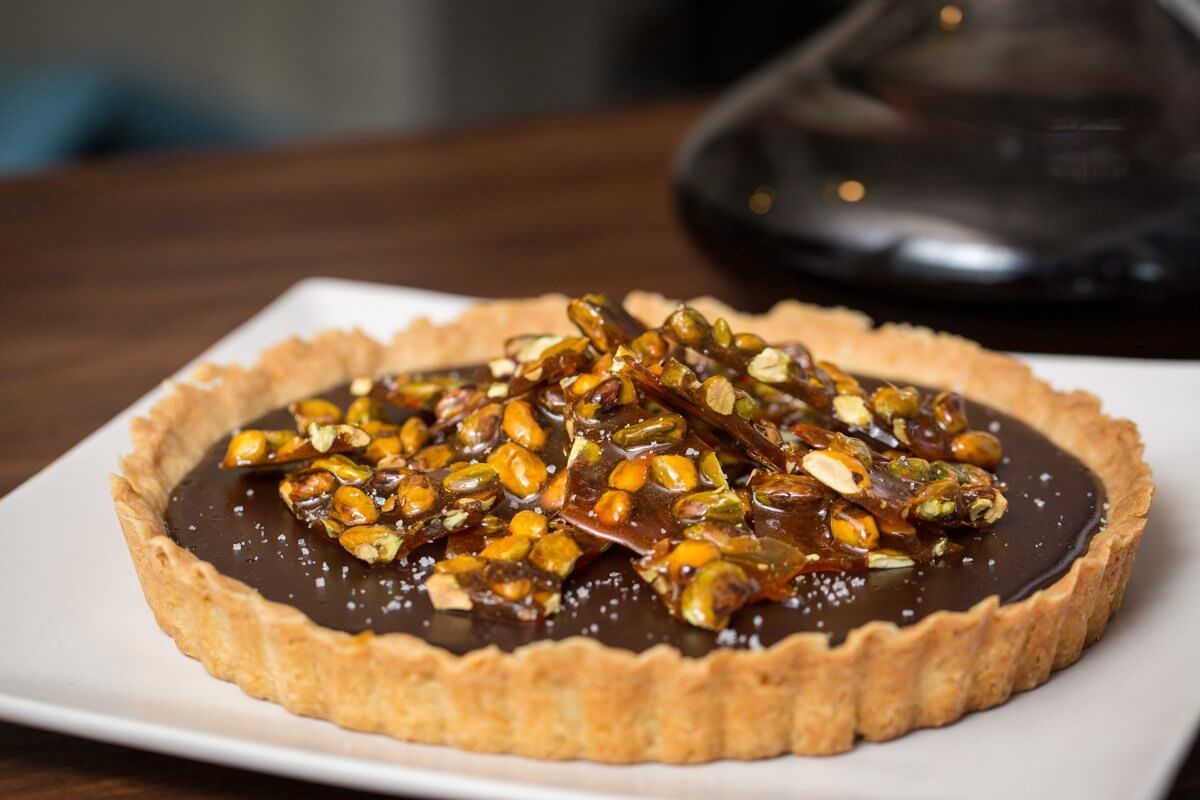 Chocolate tart with salted caramelized pistachios