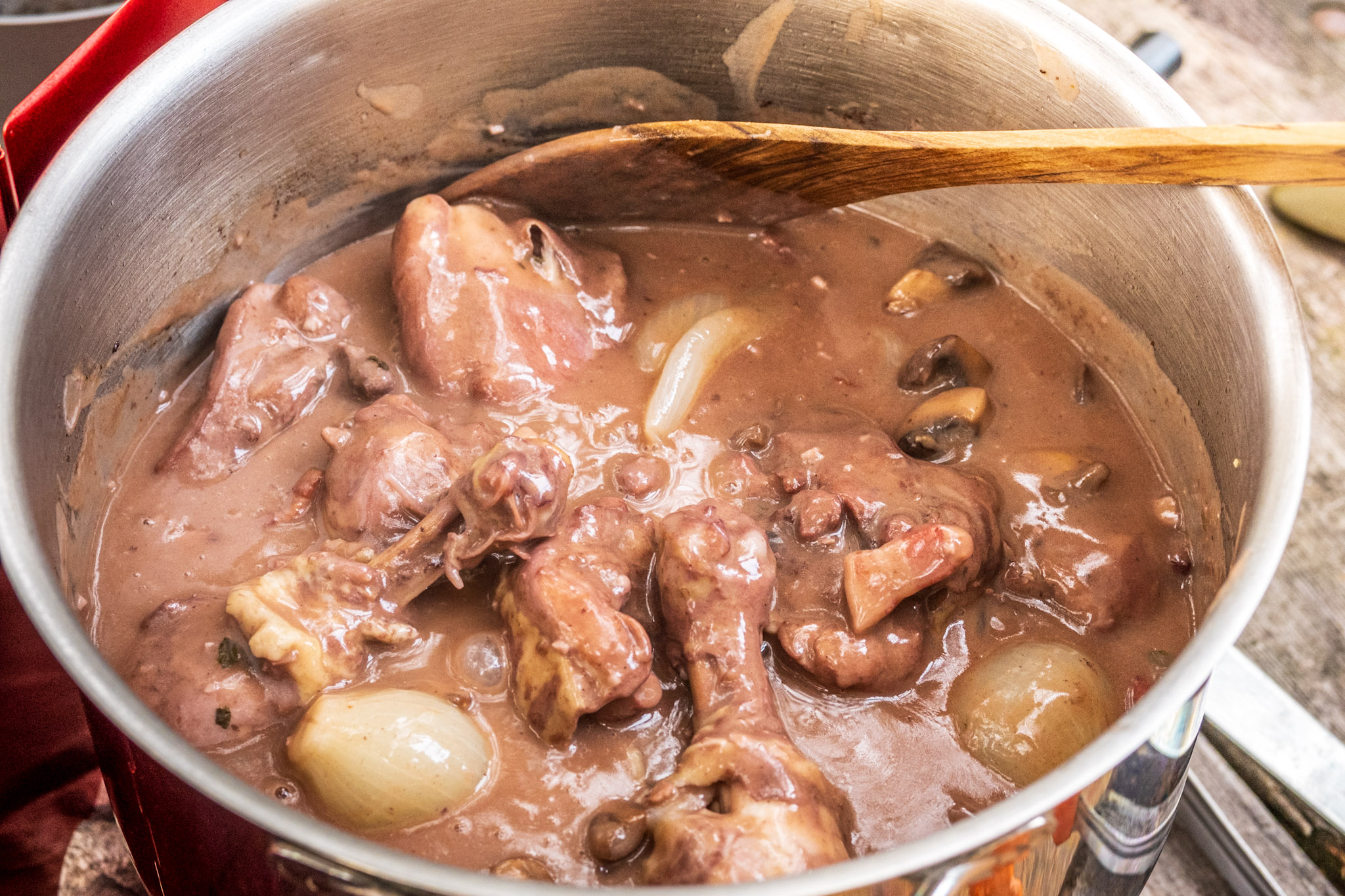 Coq au vin in a pot before serving