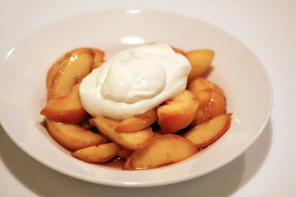 Marinated peaches with honey whipped cream