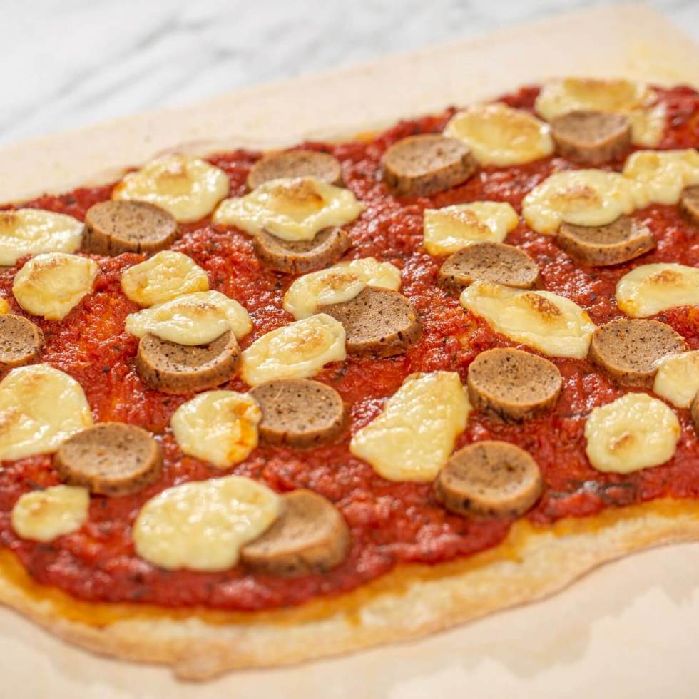 Vegan pizza with seitan Italian sausage and cashew mozzarella cheese