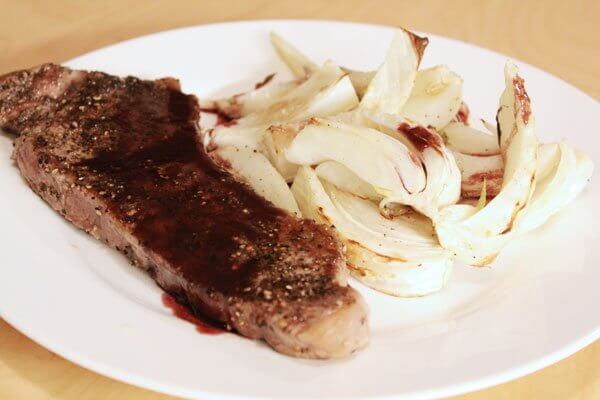 New York strip steak au poivre with roasted fennel