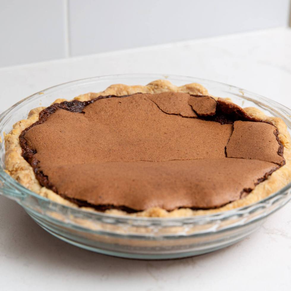 Chocolate chess pie on a white marble countertop